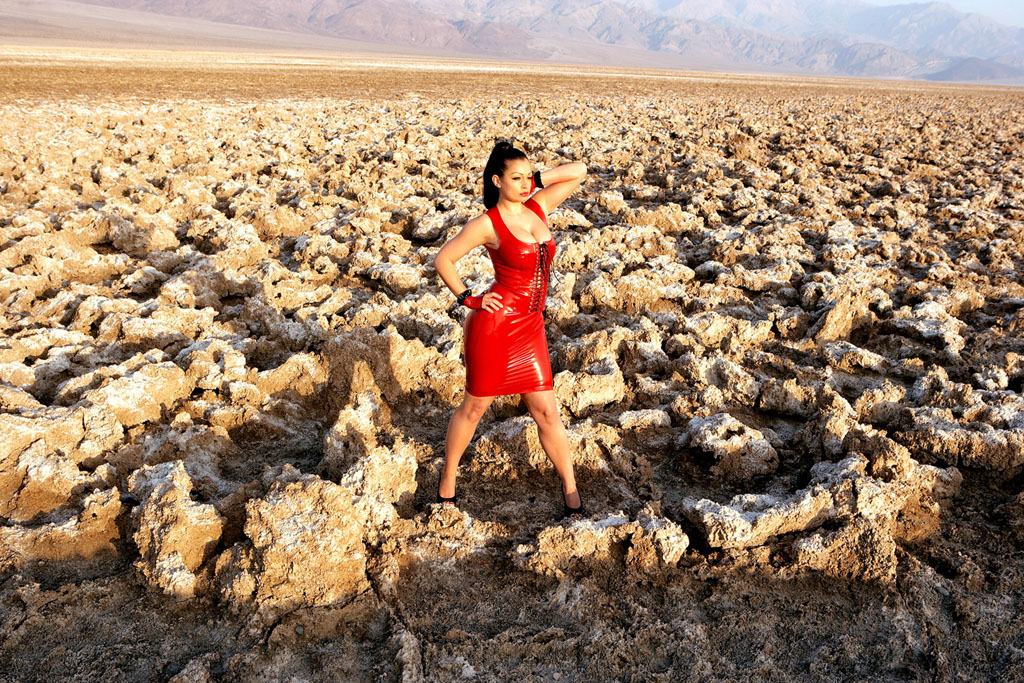 Aria Giovanni posing in red latex in the desert sun