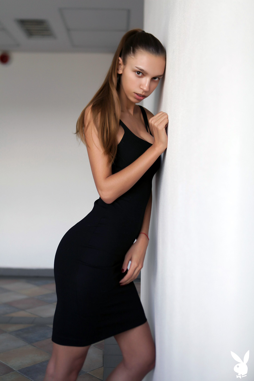 Aya Beshen slips out of her long fitted black dress