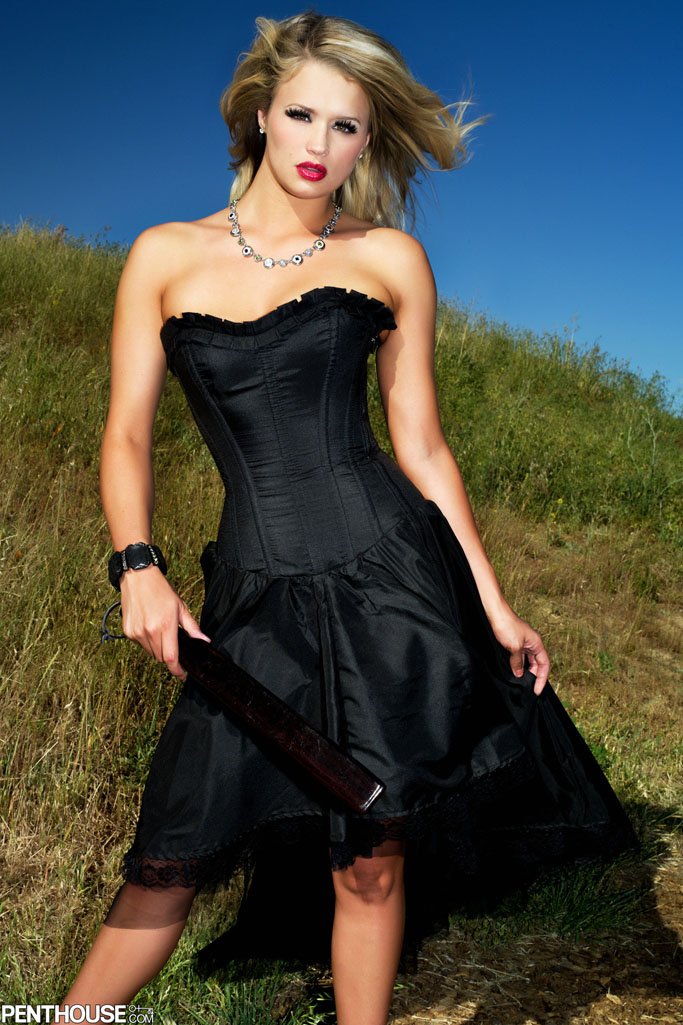 Heather Starlet poses in a black dress in the wild country