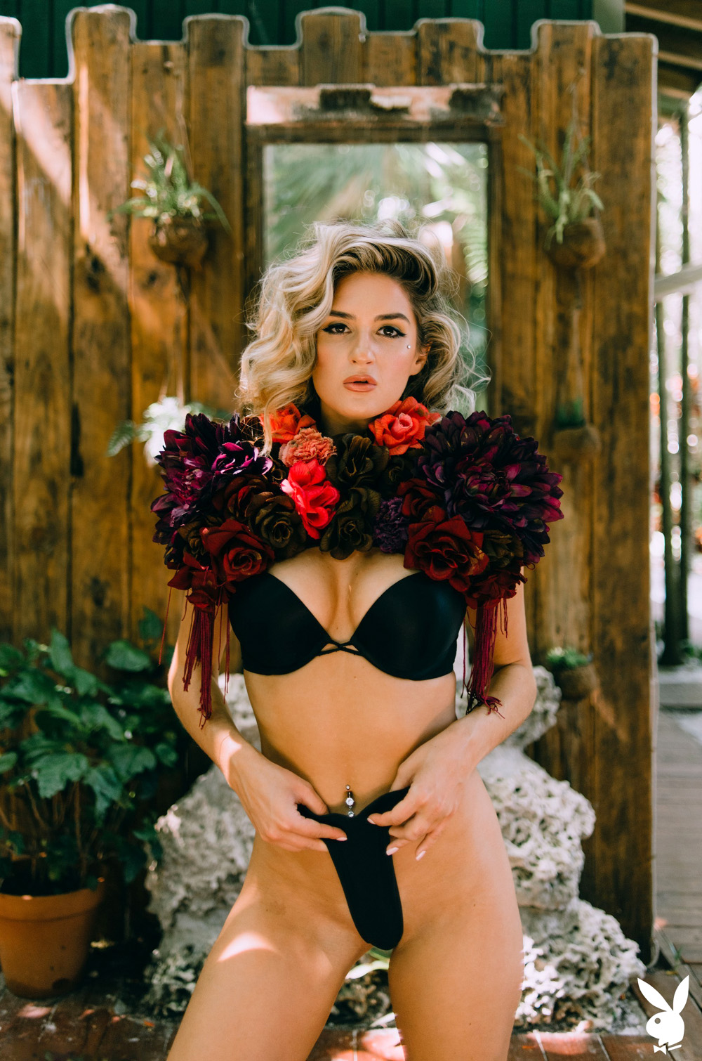 Kayci Darko exposes her perfect curves among the lush palm trees