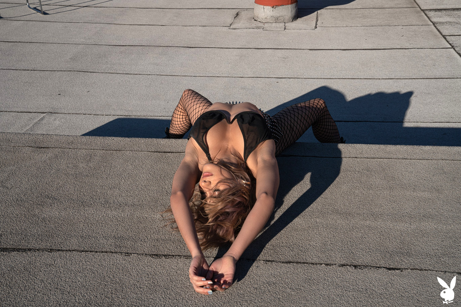 Mia Valentine exposes her spectacular curves on the office building's rooftop